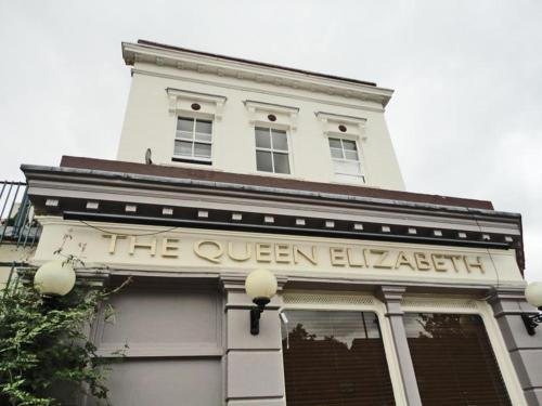 a white building with a sign on the front of it at Queen Elizabeth Hostel in London