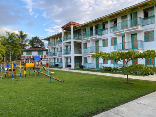 a building with a playground in front of a building at Hotel Campestre Paraiso Cafetero in Montenegro