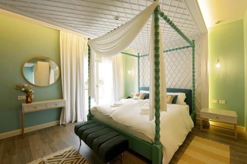 a bedroom with a canopy bed and a mirror at Çoçja Boutique Hotel in Shkodër