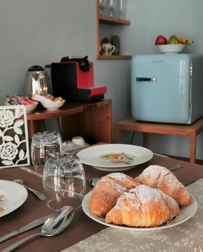 a table with plates of bread and wine glasses at Chez Moi Charme B&B in Lecce