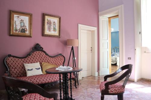 a living room with a couch and a table at Chez Moi Charme B&B in Lecce