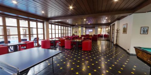 a restaurant with tables and chairs and a pool table at Te'Dreri - Llogora Tourist Village in Dhërmi