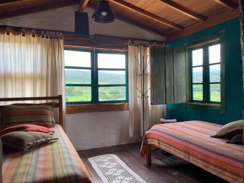 Ένα ή περισσότερα κρεβάτια σε δωμάτιο στο Chalé Mata Virgem