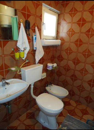 a bathroom with a toilet and a sink at Room in apartment with a host in the center of Bar in Bar