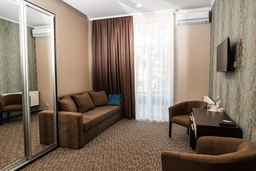 a living room with a couch and a mirror at Hotel Shengen "Шенген" in Kropyvnytskyi