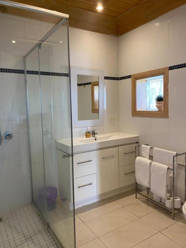 a bathroom with a shower and a sink and a mirror at Stella's Dromana Hotel in Dromana