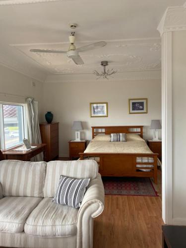 a living room filled with furniture and a window at Stella's Dromana Hotel in Dromana