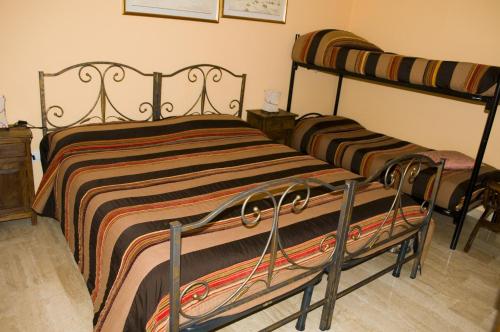 a bedroom with two bunk beds in a room at affittacamere S'Ortensia in Mamoiada