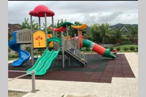a playground with a slide in a park at A home away from home in Richmond