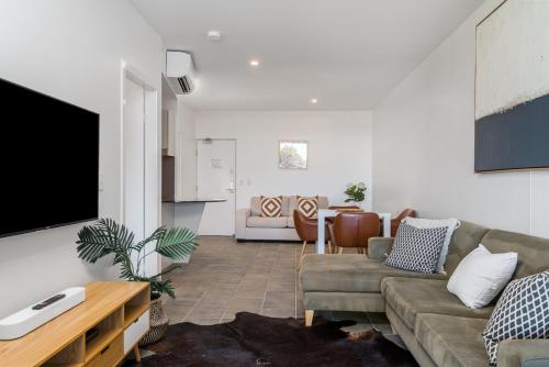 a living room filled with furniture and a couch at Lennox Holiday Apartments in Lennox Head