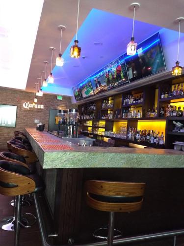 a bar in a restaurant with bar stools at Crowne Plaza Leon by IHG in León