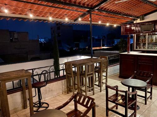 un bar con mesas y sillas en el balcón en Hotel Boutique Tehuacan, en Tehuacán