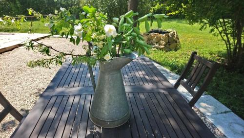 a vase with flowers in it sitting on a table at L'Esperluette en Camargue in Uchaud