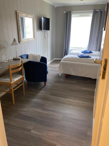 a hotel room with a bed and a chair at Førde Pensjonat in Førde