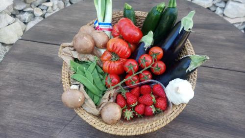 a basket of fruits and vegetables on a table at L'Esperluette en Camargue in Uchaud