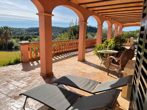 a patio with chairs and a table on a patio at Monnaber Nou Finca Hotel & Spa in Campanet