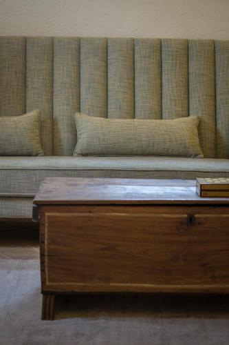 a couch with a coffee table in a room at Hotel Mas del Sol in Vall-Llobrega