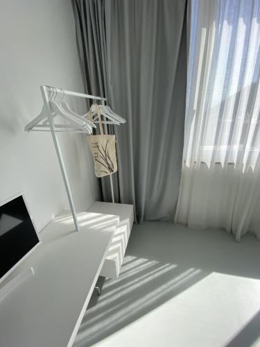 a white room with a chair and a window at Villa La Pergola Capri in Capri
