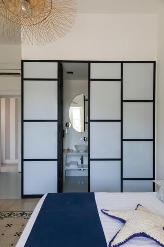 a bedroom with a bed and a mirror at Villa La Pergola Capri in Capri