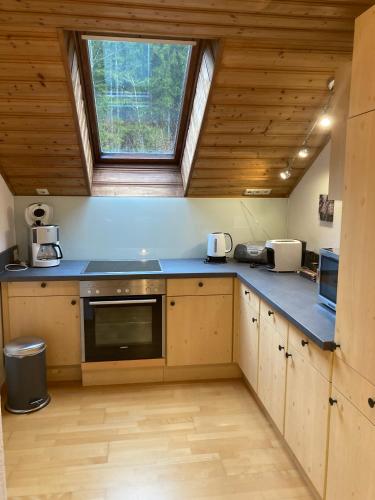 a kitchen with a blue counter top and a window at Apartment Stadler in Obertraun