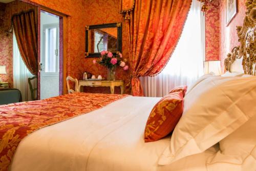 a bedroom with a large bed and a window at Hotel Santo Stefano in Venice