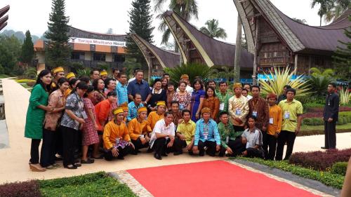 a group of people posing for a picture in front of a building at Toraja Misiliana Hotel in Rantepao