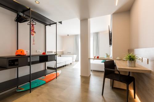 a living room with a bed and a dining room at GoTì Hotel in Nago-Torbole