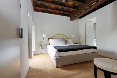 a bedroom with a large bed with a wooden ceiling at Il mulino di Trastevere - My Extra Home in Rome