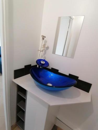 un bol bleu sur un comptoir blanc avec un miroir dans l'établissement Nice Vue Mer 50m plage Parking, à Nice