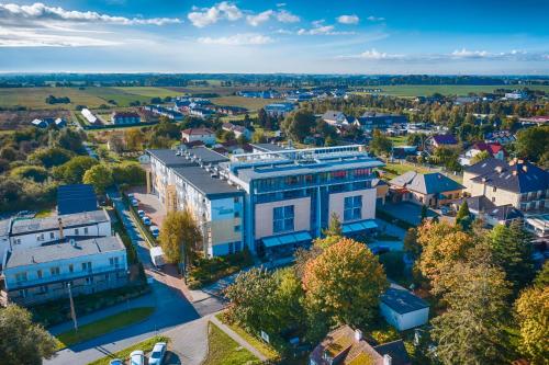 an aerial view of a town with a building at ATRIUM Sarbinowo Na Fali in Sarbinowo