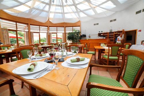 a dining room with a table and chairs with glasses at Hildegard Forum in Bingen am Rhein