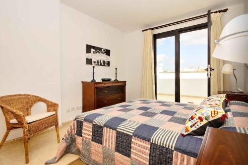 a bedroom with a bed and a view of the ocean at La Casa de Lela in Arrecife