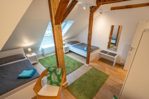 an attic room with a bed and a mirror at Wohnen wie zu Hause in Essen