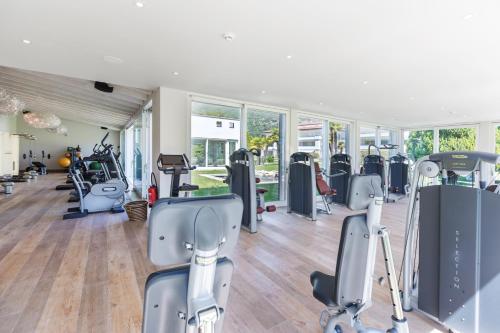 a gym with treadmills and elliptical machines at Parkhotel Delta, Wellbeing Resort in Ascona