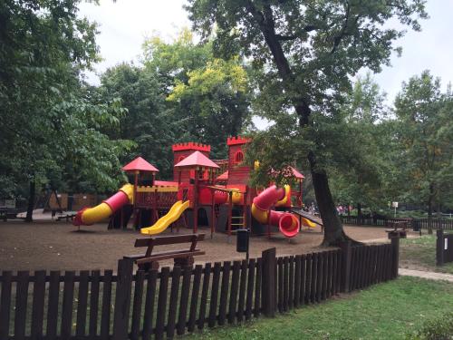 a playground with a slide in a park at Mimi Apartment in Nyíregyháza