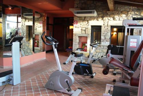 a gym with several exercise bikes in a room at Casanova - Panoramic Rooms and Suites in San Quirico dʼOrcia