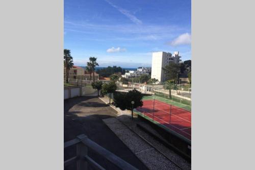 a view of a tennis court from a balcony at Beautiful Apartment Palames in Sesimbra