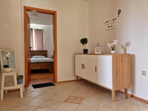 a living room with a dresser and a mirror at M&M Apartment in Zgornje Gorje