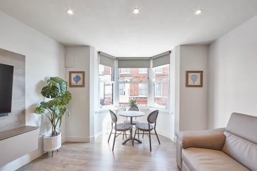 a living room with a table and chairs and a couch at Host & Stay - The Merchants Quarters in Scarborough