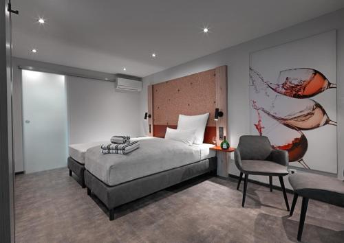 a bedroom with a bed and a desk and a chair at WeinMotel Simon 1 a in Alzenau in Unterfranken