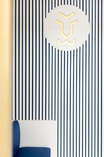 a wall with a sign with a letter k on it at Hôtel Byakko Nice in Nice
