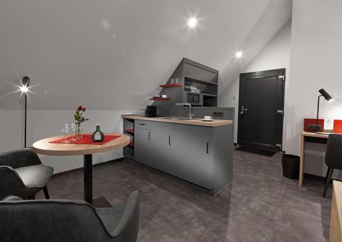 a kitchen with a counter and a table in a room at WeinMotel Simon 1 a in Alzenau in Unterfranken