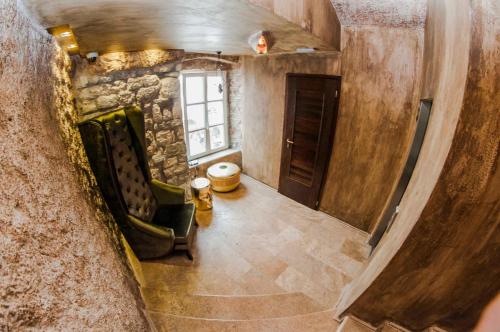 an overhead view of a living room with a stone wall at Boutique Hotel Astoria in Kotor