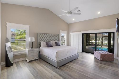 a bedroom with a bed and a ceiling fan at Stunning home with pool, dock and direct gulf access in Marco Island