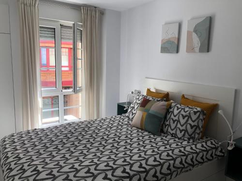 מיטה או מיטות בחדר ב-Apartamento Playa San Lorenzo Garaje opcional