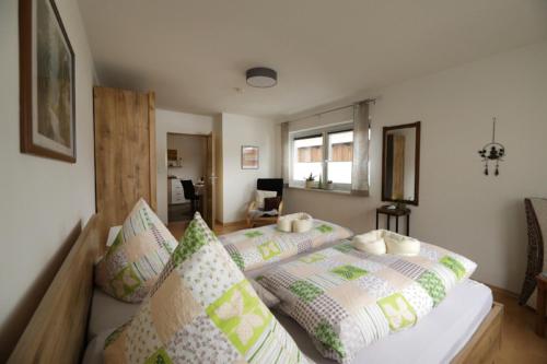 a bedroom with a bed with pillows on it at Ferienhof Neukirchinger in Tiefenbach