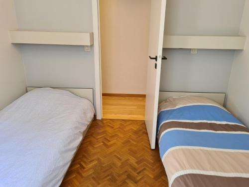 a small room with two beds in it at Oostduinkerke Apartments in Oostduinkerke