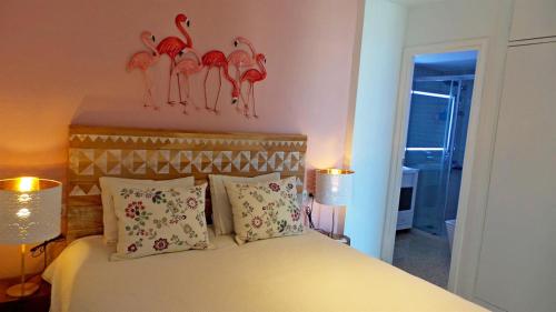 a bedroom with a bed with two flamingos on the wall at Sea Views and big balcony in Torremolinos