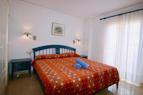 Un dormitorio con una cama con un objeto azul. en La Pata, en Denia