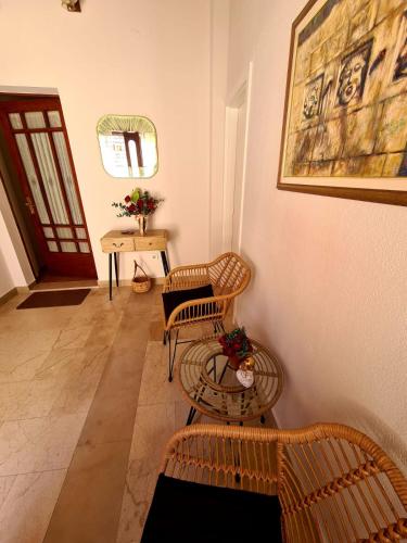 a living room with two chairs and a table at Apartments Olga 2 in Makarska